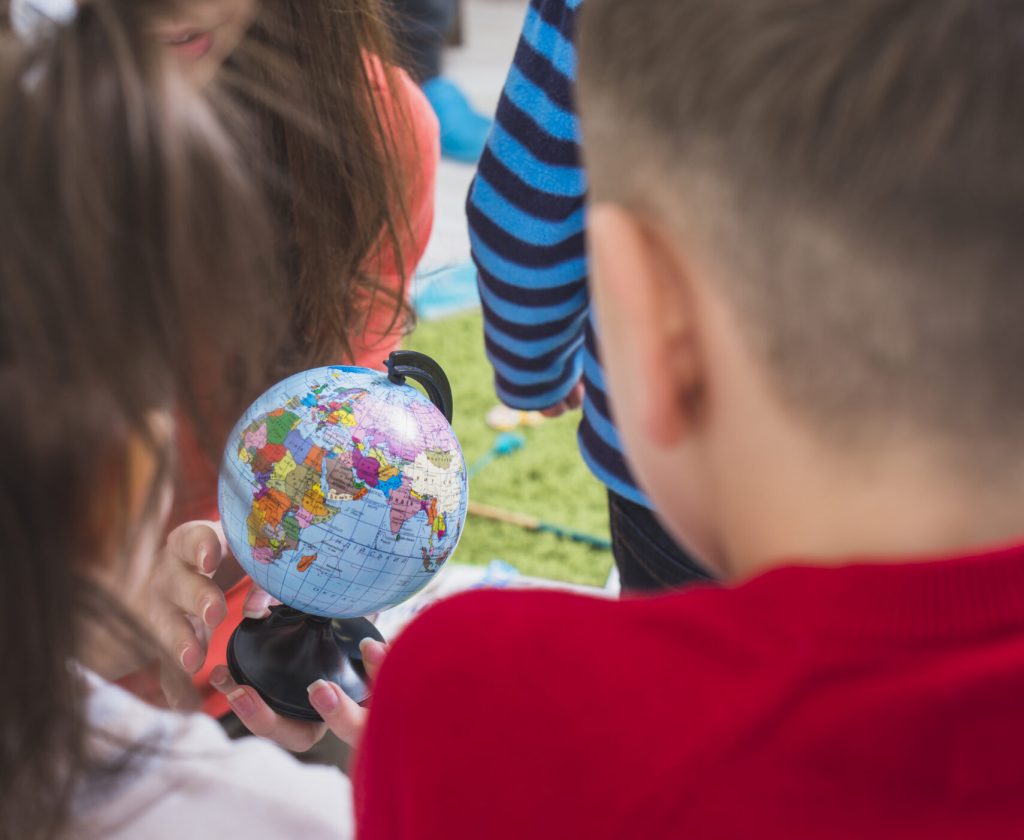 teacher-children-looking-globe